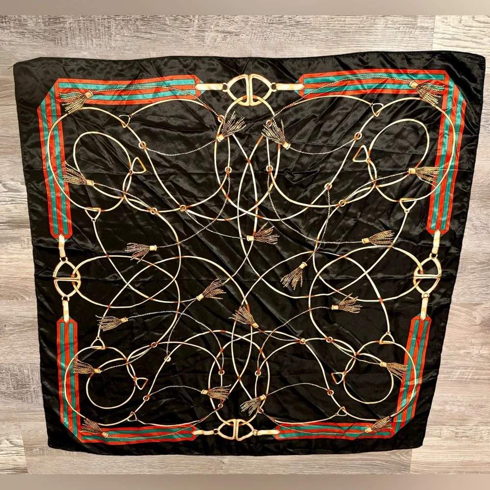 Fashionable women's black scarf with a chain and print. Polyester.